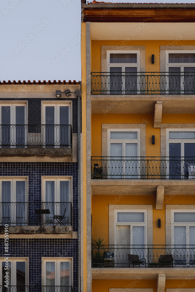 Fototapeta premium Several structures in yellow and blue with balconies