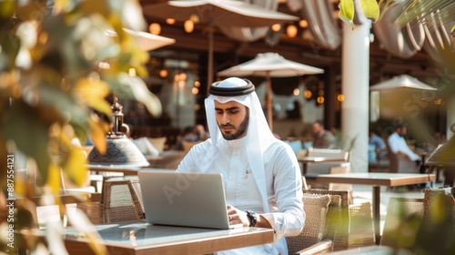 Wallpaper Mural Arabic businessman sitting in outdoor restaurant working online with laptop computer. Middle eastern man business manager using laptop, Concept of business, finance, modern technologies Torontodigital.ca