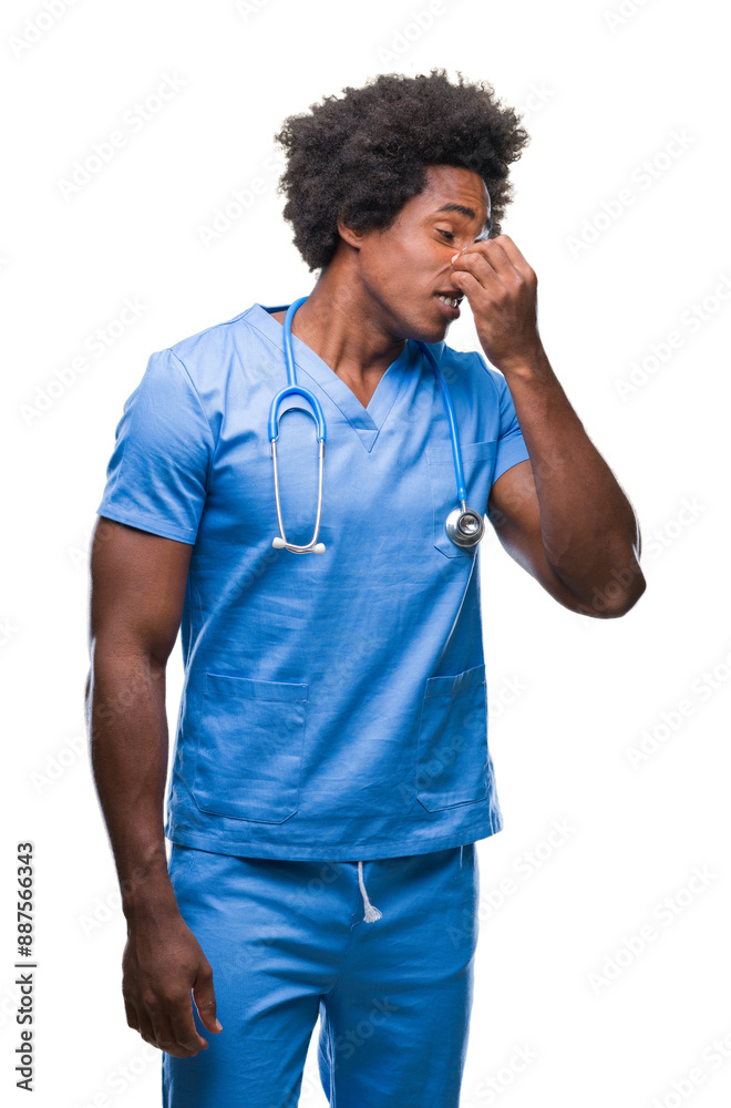 Afro american surgeon doctor man over isolated background smelling something stinky and disgusting, intolerable smell, holding breath with fingers on nose. Bad smells concept. Afro american surgeon doctor man over isolated background smelling something stinky and disgusting, intolerable smell, holding breath with fingers on nose. Bad smells concept.