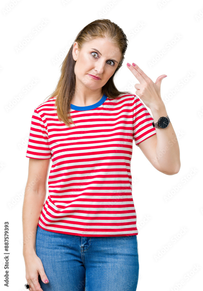 Middle age mature woman wearing casual t-shirt over isolated background Shooting and killing oneself pointing hand and fingers to head, suicide gesture. Middle age mature woman wearing casual t-shirt over isolated background Shooting and killing oneself pointing hand and fingers to head, suicide gesture.