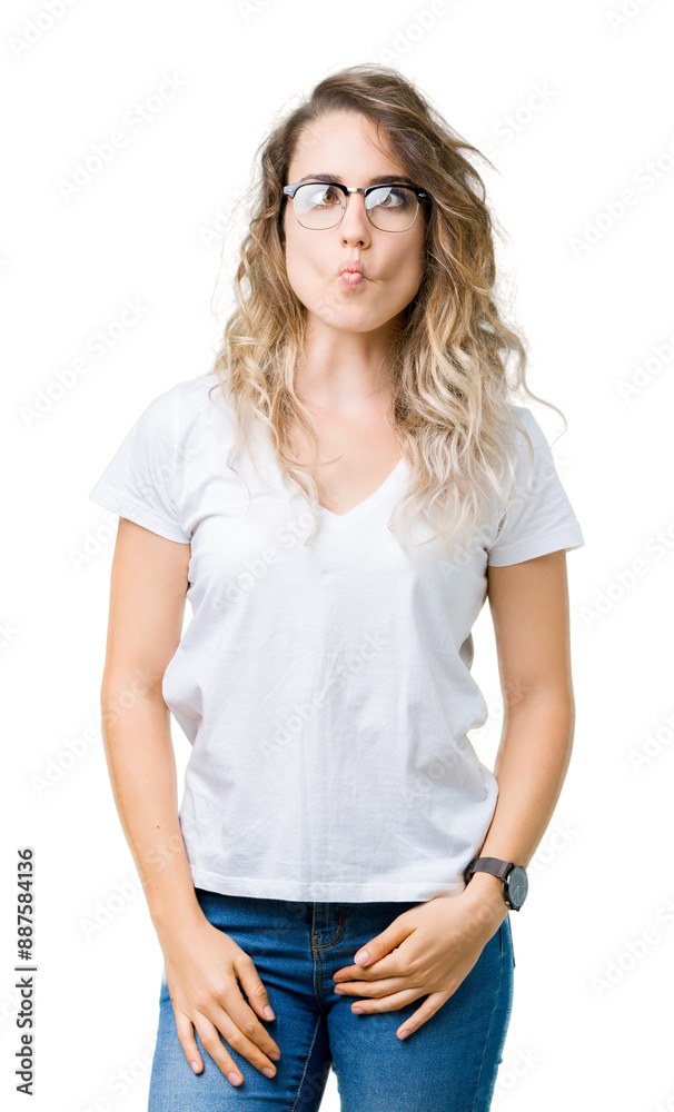 Beautiful young blonde woman wearing glasses over isolated background making fish face with lips, crazy and comical gesture. Funny expression. Beautiful young blonde woman wearing glasses over isolated background making fish face with lips, crazy and comical gesture. Funny expression.