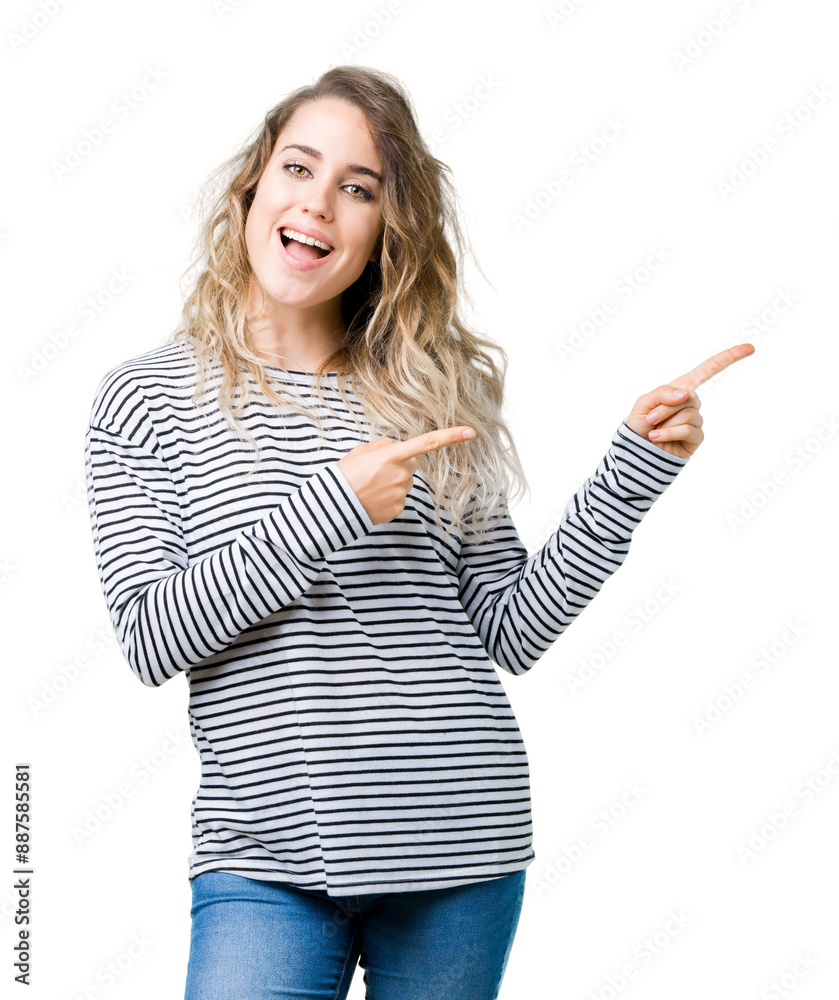 Beautiful young blonde woman wearing stripes sweater over isolated background smiling and looking at the camera pointing with two hands and fingers to the side. Beautiful young blonde woman wearing stripes sweater over isolated background smiling and looking at the camera pointing with two hands and fingers to the side.