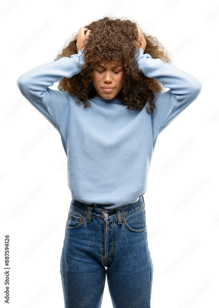 African american woman wearing a sweater suffering from headache desperate and stressed because pain and migraine. Hands on head. African american woman wearing a sweater suffering from headache desperate and stressed because pain and migraine. Hands on head.