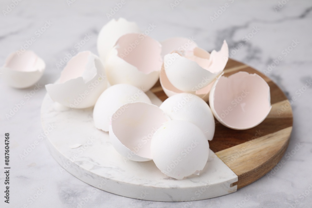 Broken eggshells on light marble table, closeup Broken eggshells on light marble table, closeup