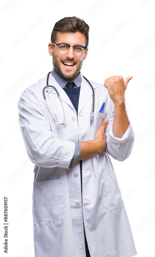 Young handsome doctor man over isolated background smiling with happy face looking and pointing to the side with thumb up.