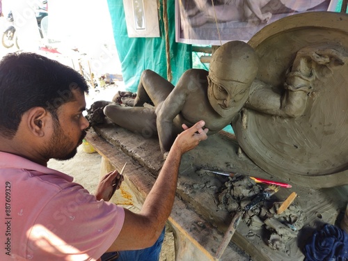 Indian Sculptor Artist shaping a clay sculpture, Greek and Roman Sculpture. This sculpture representing the Trojan king Laomedon. photo