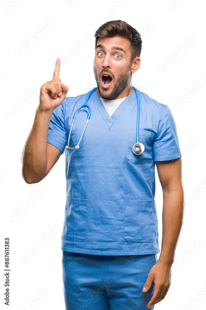 Young handsome doctor surgeon man over isolated background pointing finger up with successful idea. Exited and happy. Number one. Young handsome doctor surgeon man over isolated background pointing finger up with successful idea. Exited and happy. Number one.