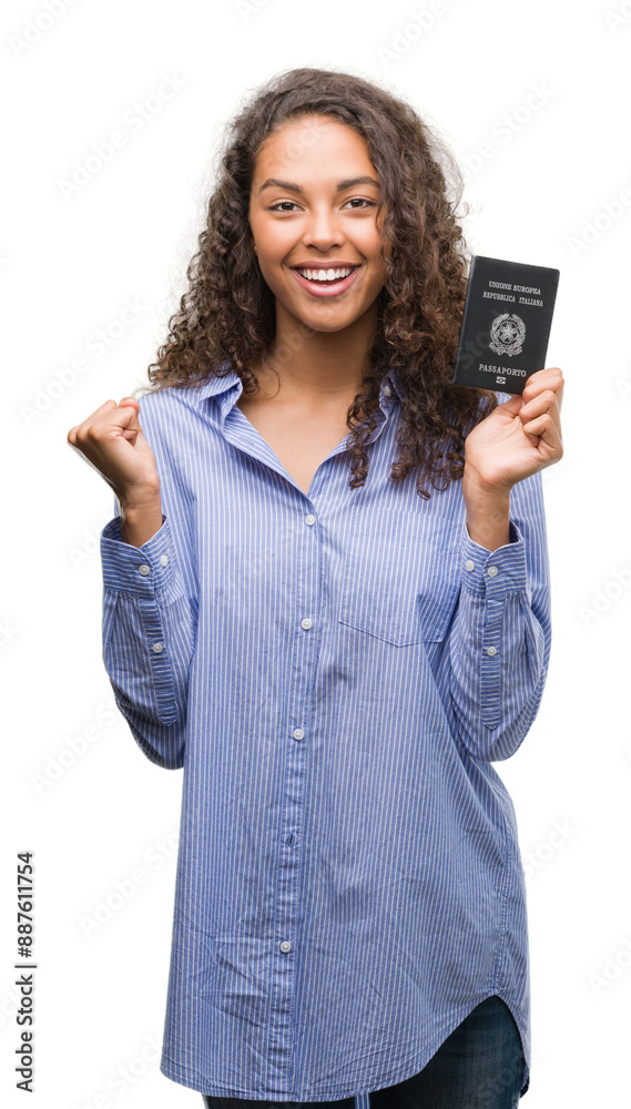 Young hispanic woman holding passport of Italy screaming proud and celebrating victory and success very excited, cheering emotion Young hispanic woman holding passport of Italy screaming proud and celebrating victory and success very excited, cheering emotion