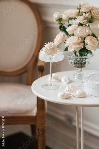 flowers in a glass. Three times in a glass. Light soft colors. Aesthetics. Marshmallows on the table.