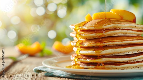 Delicious pancakes with honey and peaches for a tasty breakfast photo