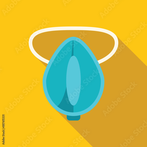 Blue oxygen mask hanging on yellow wall with long shadow