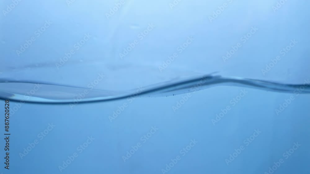 Fluid Dynamics Macro View of Fresh Water Droplets in Motion. Nature's Symphony Slow-Motion Water Ripple Effect in Blue Hue. Fluid Dynamics Macro View of Fresh Water Droplets in Motion. Nature's Symphony Slow-Motion Water Ripple Effect in Blue Hue.
