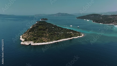 Drone aerial view of Otocic Sveta Fumija, Croatia, showcasing its stunning coastline and clear waters. photo