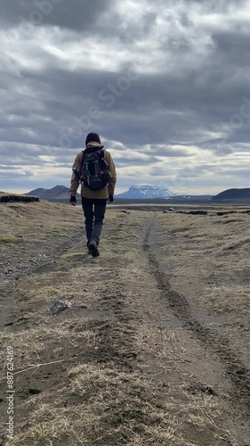 man walks the Icelandic lava desert to a volcano Herðubreið photo