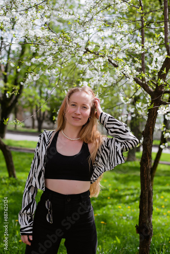 Young woman in spring near blooming trees