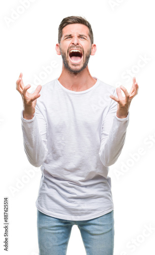 Young handsome man over isolated background crazy and mad shouting and yelling with aggressive expression and arms raised. Frustration concept.