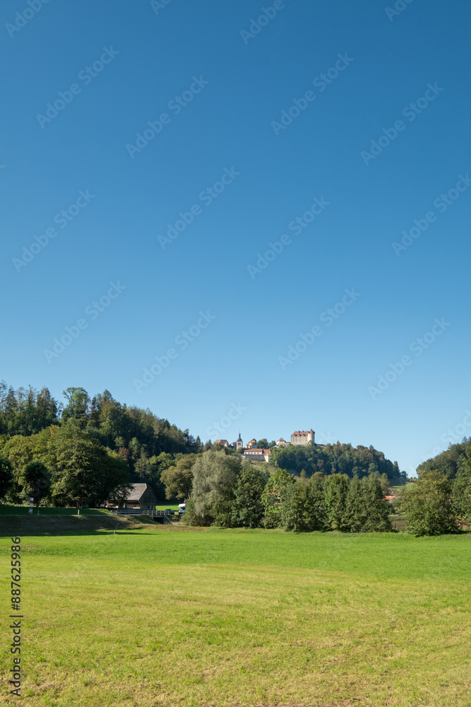 A beautiful, serene landscape with a large castle in the distance A beautiful, serene landscape with a large castle in the distance