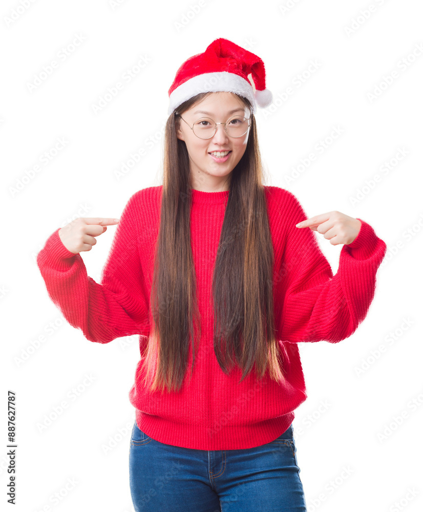 Young Chinese woman over isolated background wearing christmas hat looking confident with smile on face, pointing oneself with fingers proud and happy. Young Chinese woman over isolated background wearing christmas hat looking confident with smile on face, pointing oneself with fingers proud and happy.
