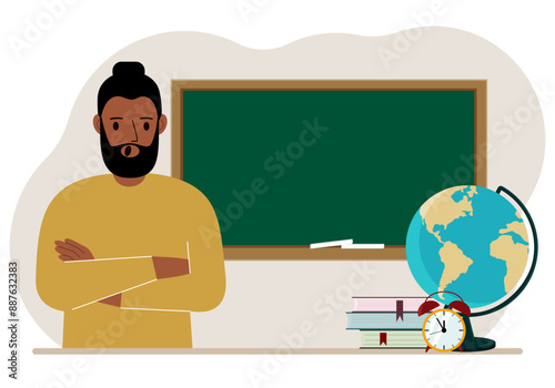 Male teacher near the blackboard. The concept of education, teaching, teacher's day.