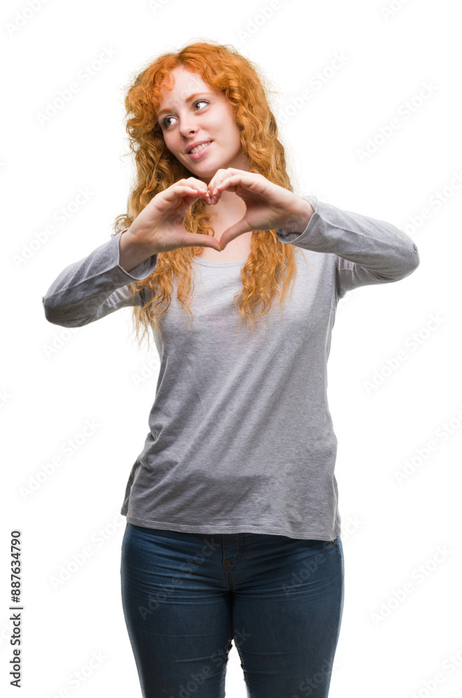 Young redhead woman smiling in love showing heart symbol and shape with hands. Romantic concept. Young redhead woman smiling in love showing heart symbol and shape with hands. Romantic concept.