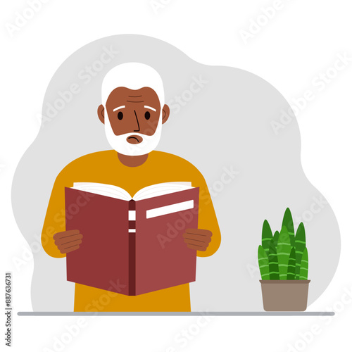 The man is holding a large book in his hands.