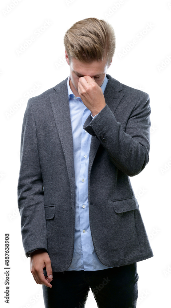 Young handsome blond business man tired rubbing nose and eyes feeling fatigue and headache. Stress and frustration concept. Young handsome blond business man tired rubbing nose and eyes feeling fatigue and headache. Stress and frustration concept.