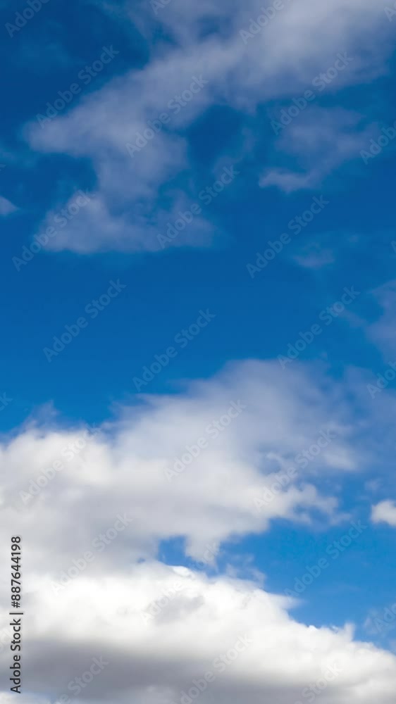 White thick clouds flying quickly by the skies. Rainy clouds formation in the atmosphere. Low angle view. Timelapse. Vertical video White thick clouds flying quickly by the skies. Rainy clouds formation in the atmosphere. Low angle view. Timelapse. Vertical video