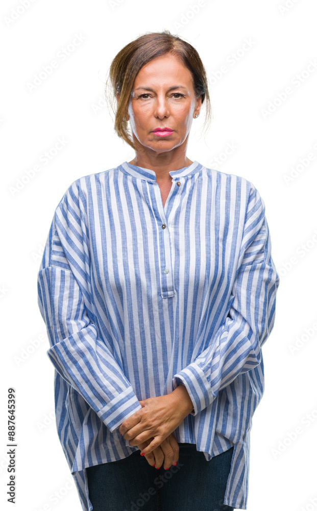 Middle age senior hispanic woman over isolated background with serious expression on face. Simple and natural looking at the camera. Middle age senior hispanic woman over isolated background with serious expression on face. Simple and natural looking at the camera.