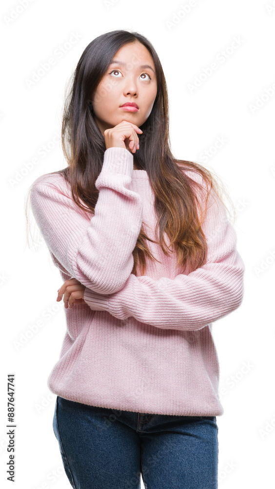 Young asian woman over isolated background with hand on chin thinking about question, pensive expression. Smiling with thoughtful face. Doubt concept. Young asian woman over isolated background with hand on chin thinking about question, pensive expression. Smiling with thoughtful face. Doubt concept.