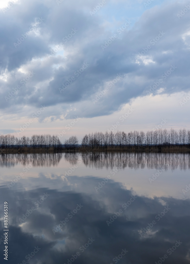 a beautiful reflection of the sky and clouds in the lake at sunset a beautiful reflection of the sky and clouds in the lake at sunset