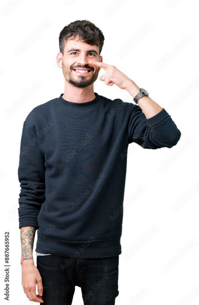 Young handsome man over isolated background Pointing with hand finger to face and nose, smiling cheerful