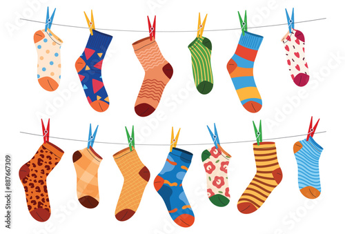 Cotton and woolen socks in various patterns hang on lines to dry. Fashionable clothing accessories. Vector illustration