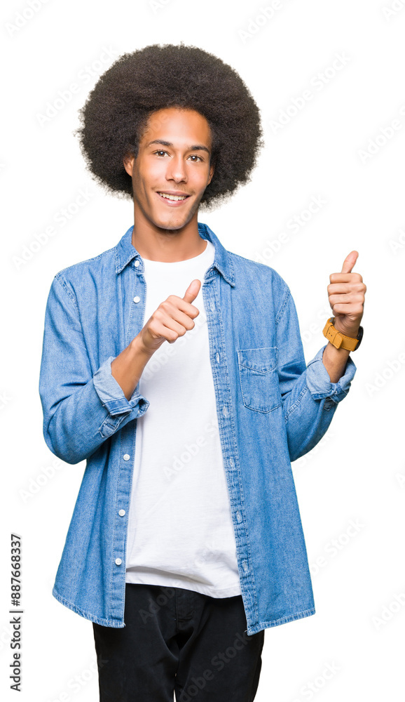 Young african american man with afro hair Pointing to the back behind with hand and thumbs up, smiling confident Young african american man with afro hair Pointing to the back behind with hand and thumbs up, smiling confident