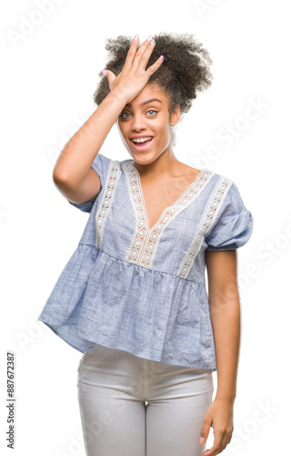 Young afro american woman over isolated background surprised with hand on head for mistake, remember error. Forgot, bad memory concept.