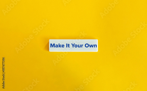 Make It Your Own Phrase. Concept of Individual Style, Personalised Content. Blue Text on Block Letter Tile against Yellow Background. photo