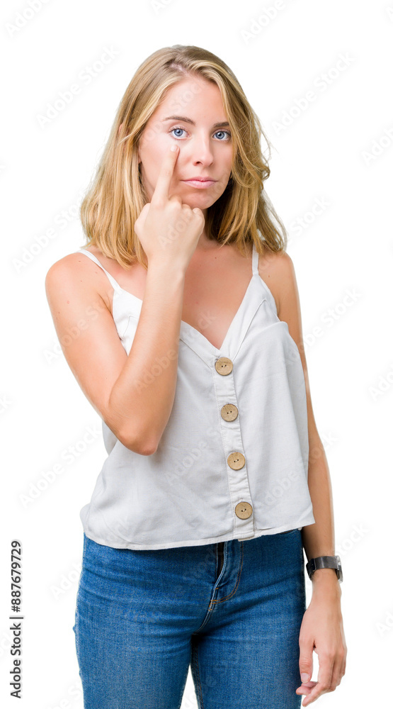 Beautiful young woman over isolated background Pointing to the eye watching you gesture, suspicious expression Beautiful young woman over isolated background Pointing to the eye watching you gesture, suspicious expression