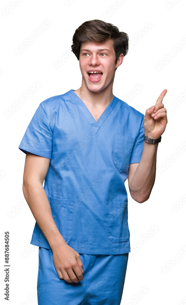 Young doctor wearing medical uniform over isolated background with a big smile on face, pointing with hand and finger to the side looking at the camera.