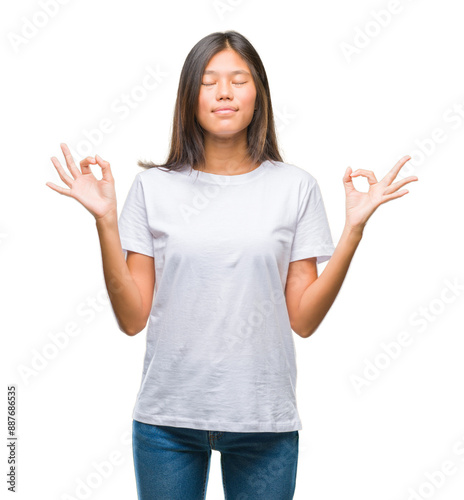 Young asian woman over isolated background relax and smiling with eyes closed doing meditation gesture with fingers. Yoga concept.