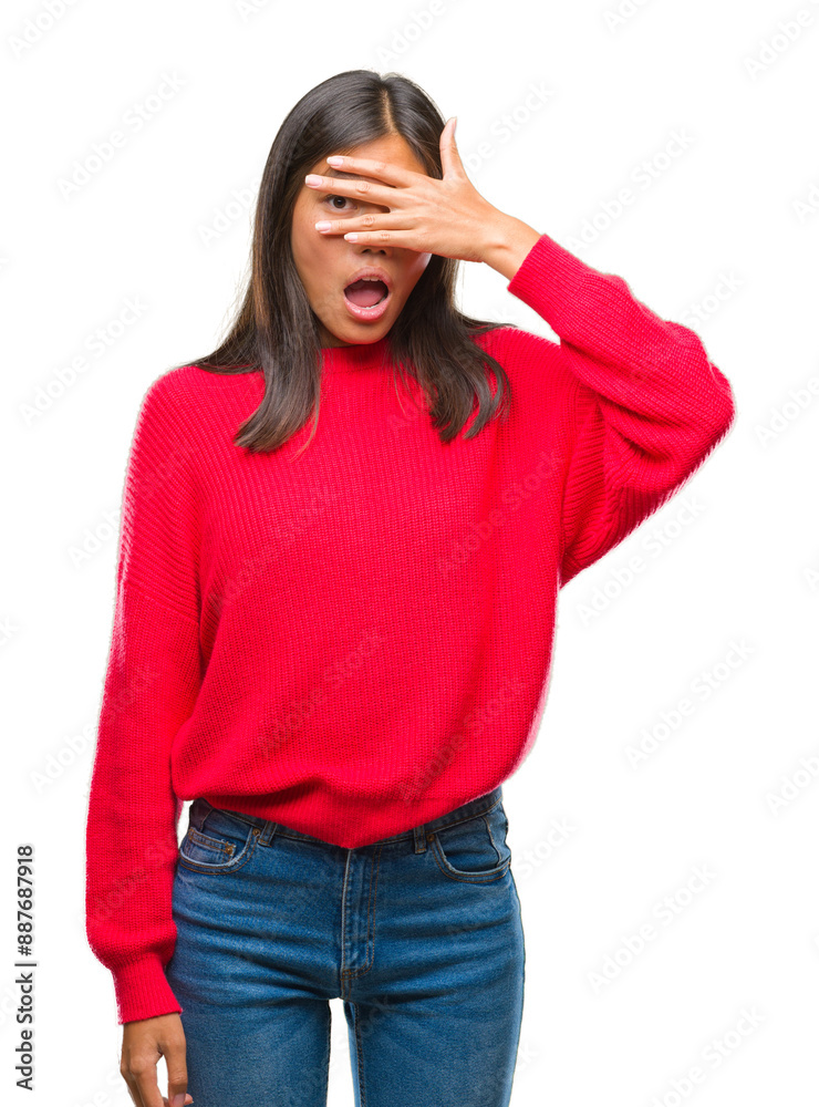 Young asian woman wearing winter sweater over isolated background peeking in shock covering face and eyes with hand, looking through fingers with embarrassed expression. Young asian woman wearing winter sweater over isolated background peeking in shock covering face and eyes with hand, looking through fingers with embarrassed expression.