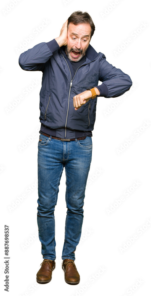 Naklejka premium Middle age handsome man wearing a jacket Looking at the watch time worried, afraid of getting late