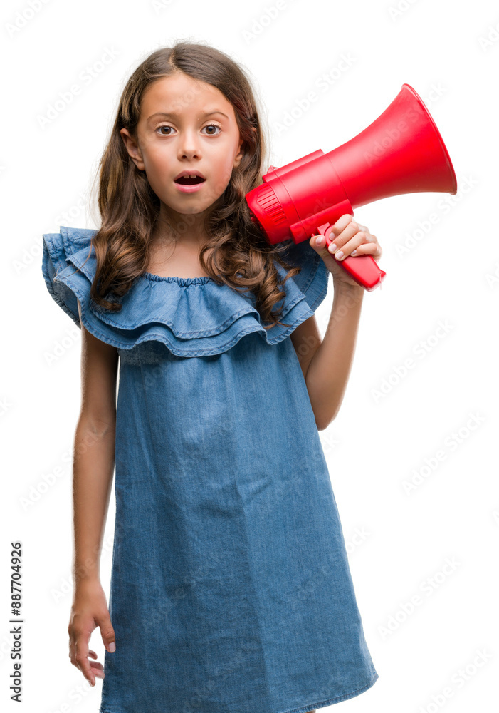 Brunette hispanic girl holding red megaphone scared in shock with a surprise face, afraid and excited with fear expression Brunette hispanic girl holding red megaphone scared in shock with a surprise face, afraid and excited with fear expression