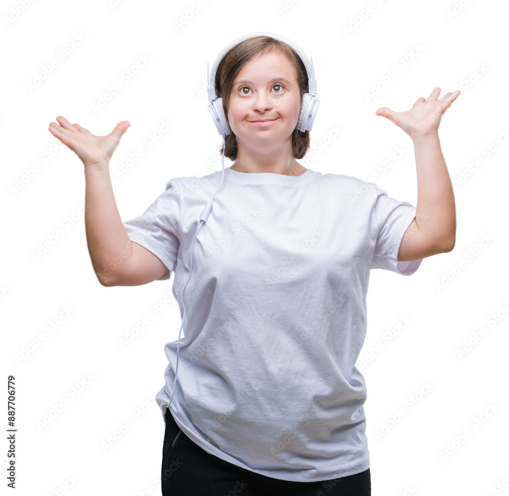 Young adult woman with down syndrome wearing headphones over isolated background crazy and mad shouting and yelling with aggressive expression and arms raised. Frustration concept. Young adult woman with down syndrome wearing headphones over isolated background crazy and mad shouting and yelling with aggressive expression and arms raised. Frustration concept.