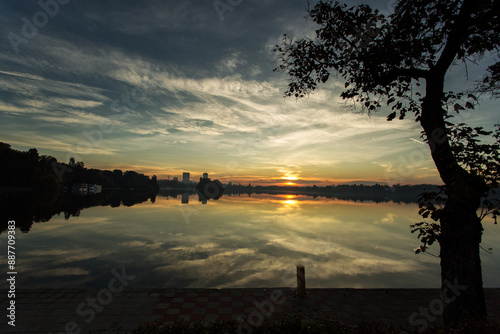 Park at sunrise with beautiful autumn colors and lake in background