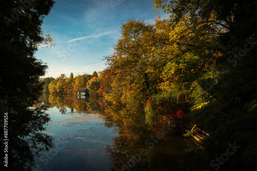 Obraz na płótnie Landscape with beautiful house on a lake with colourful leafs in autumn season w salonie