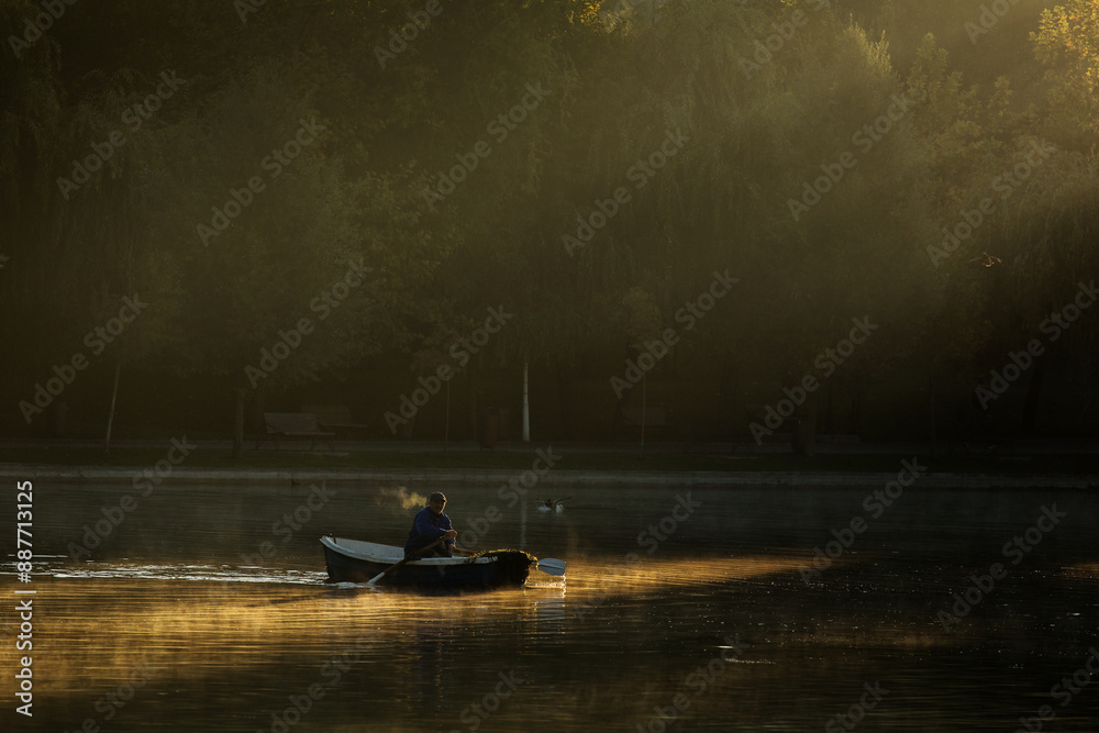 Man with the boat on lake fishing