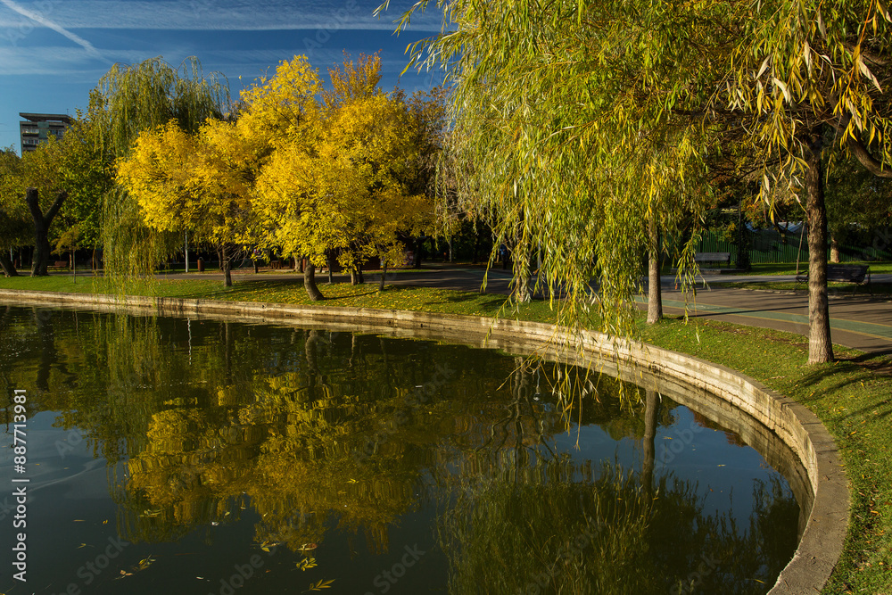 Park at sunrise with beautiful autumn colors and lake in background