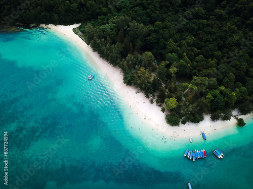 Aerial view of Perhentian Islands beach with boats docked near a wooden pier and lush greenery photo