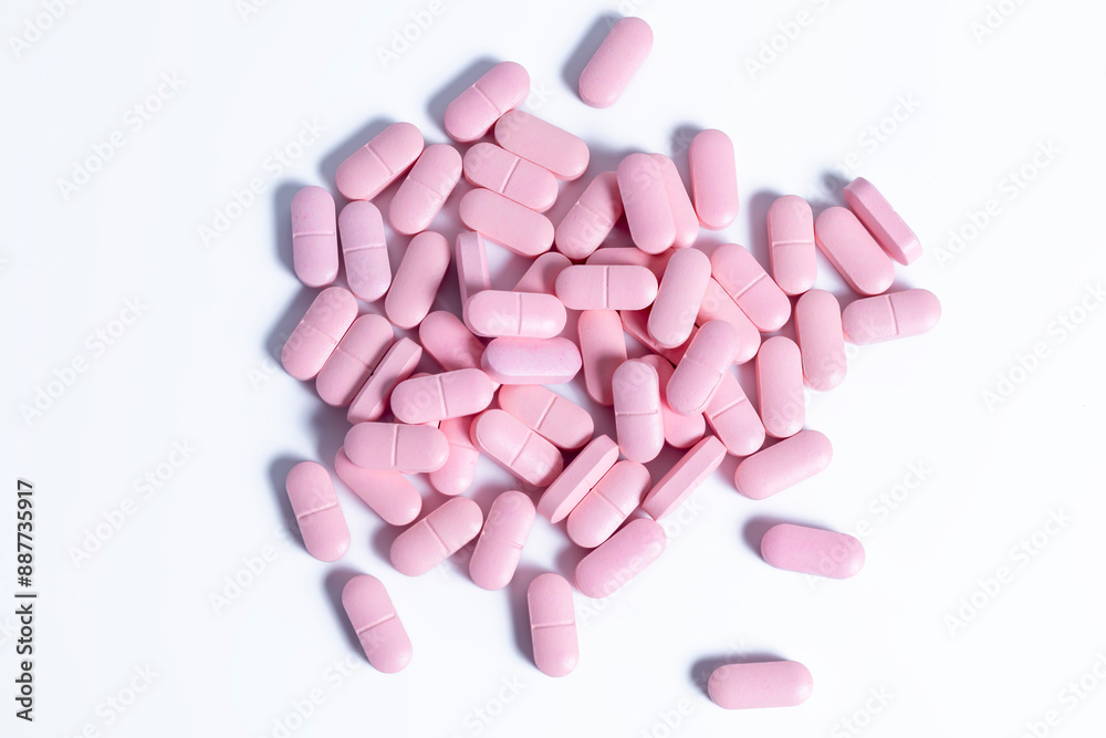 pile of pink pills isolated on white background. top view. pile of pink pills isolated on white background. top view.