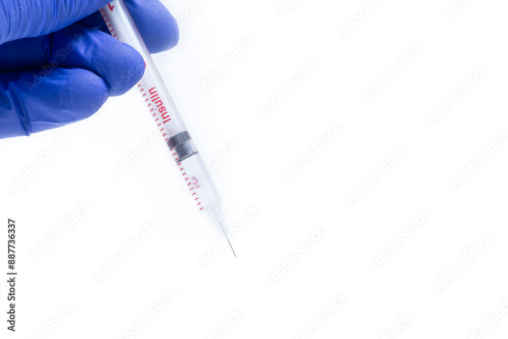 Naklejka premium Doctor in blue gloves holding syringe on white background