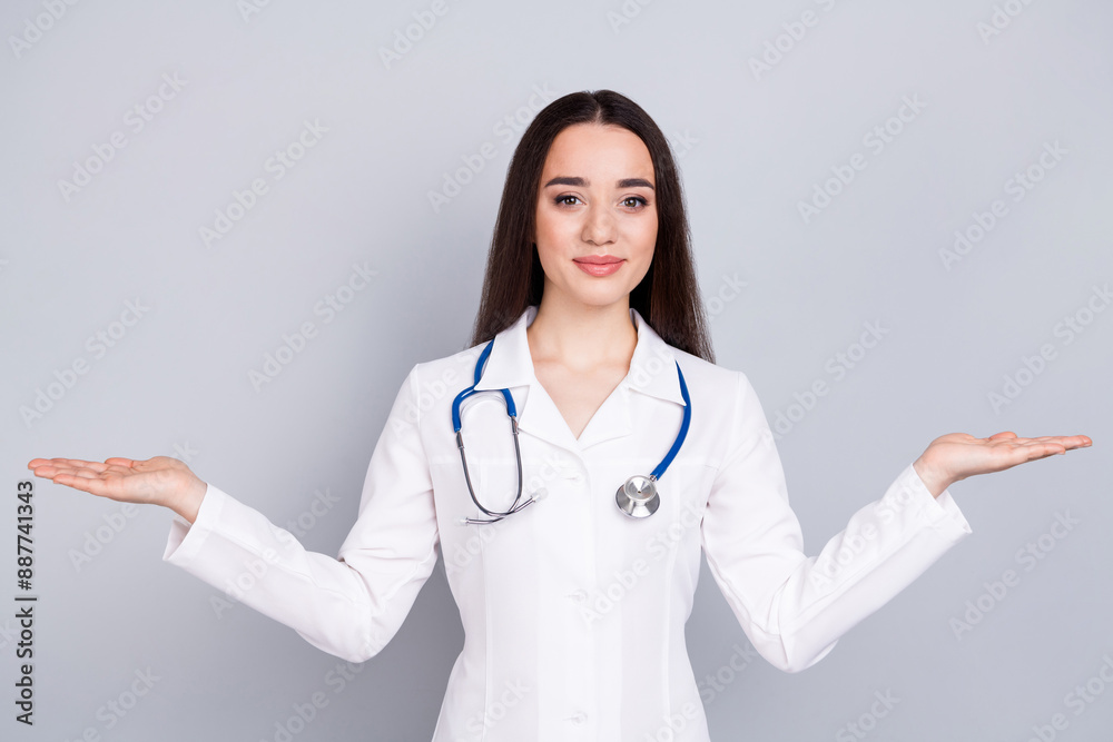 Photo of professional medical worker lady hold empty space vs white coat isolated on grey color background Photo of professional medical worker lady hold empty space vs white coat isolated on grey color background